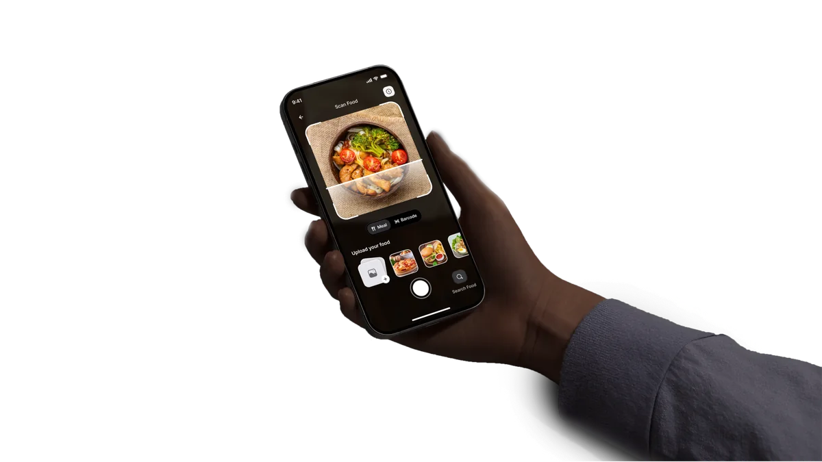 A hand holding a phone running the Kova scan screen on a bowl of food